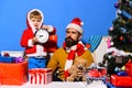 Boy and man with beard and serious faces celebrate Christmas