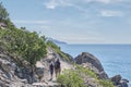 Boy and man hiking on the scenic Golitsyn trail. National botanical reserve New World, Crimea. View from back