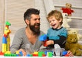 Boy and man play together. Dad and kid with toys Royalty Free Stock Photo