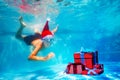 Boy in mask dive underwater for Christmas presents