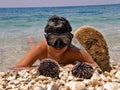 Boy with mask, urchin andcrustacean Royalty Free Stock Photo