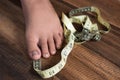 Boy measure his feet using measuring tape