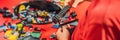 A boy in a medical mask plays with a constructor. child playing and building with colorful plastic bricks table. Early Royalty Free Stock Photo