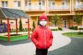 Boy with medical mask is walking alone