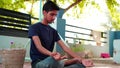 A boy is meditating at home in India. Indian young boy in a black traditional shirt sitting in a lotus position