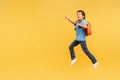 Boy in mid-stride pointing excitedly, yellow backpack