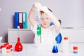 Boy mixing colored liquids in test tubes Royalty Free Stock Photo