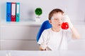 Boy mixing colored liquids in test tubes Royalty Free Stock Photo