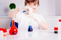 Boy mixing colored liquids in test tubes Royalty Free Stock Photo