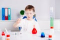 Boy mixing colored liquids in test tubes Royalty Free Stock Photo