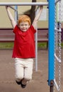 Boy on monkey bars. Little boy hanging on gym activity center of school playground. Outdoor activity for kids. Sport Royalty Free Stock Photo