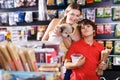 Boy with mother choosing dog treats for their puppy Royalty Free Stock Photo