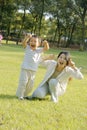 Boy and mother making faces on lawn