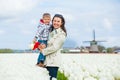 Boy with mother in the purple tulips field Royalty Free Stock Photo