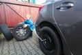 Boy mounted tires on a car. Royalty Free Stock Photo