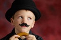 Boy with moustache and bowler Royalty Free Stock Photo