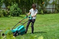 Boy mowing the lawn with lawnmower Royalty Free Stock Photo