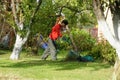 Boy mowing the lawn with lawnmower Royalty Free Stock Photo