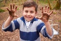 Boy With Muddy Hands Playing In Forest Royalty Free Stock Photo