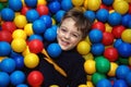 Boy in multi-coloured balls Royalty Free Stock Photo