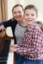 Portrait Of Boy With Music Teacher Having Lesson At Piano Royalty Free Stock Photo