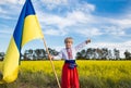 Boy in national clothes with yellow-blue large flag in hand. Children of Ukraine for peace Royalty Free Stock Photo