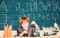 Boy near microscope and test tubes school classroom. Knowledge concept. Knowledge day. Kid study biology chemistry