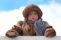 Boy Nenets reindeer herder in national dress on the sky background