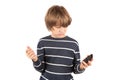 Boy not too happy with his basic mobile phone. Isolated on white Royalty Free Stock Photo