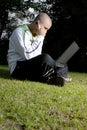 Boy with notebook and cell phone in park Royalty Free Stock Photo