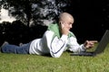 Boy with notebook and cell phone in park Royalty Free Stock Photo