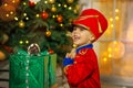 A boy in a nutcracker costume plays with the mouse symbol of the year.