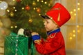 A boy in a nutcracker costume plays with the mouse symbol of the year.