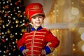 A boy in a nutcracker costume plays with the mouse symbol of the year.