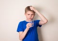 Boy observing a half full glass of water Royalty Free Stock Photo