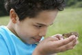 Boy Observing Toad Outdoors