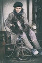 Boy on old fashioned bicycle with a black cat