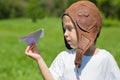 Boy in the old helmet pilot playing with toy plane Royalty Free Stock Photo