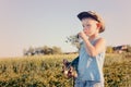 Boy with Onions Chewing on Plant Outdoors on Farm Royalty Free Stock Photo