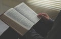 Boy opening Bible pages to study the Bible in the morning Royalty Free Stock Photo