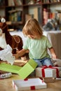 Boy opening Xmas presents. Children under Christmas tree with gift boxes Royalty Free Stock Photo
