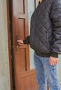 boy opens the door in the house,a teenage boy stands in front of a plastic door Royalty Free Stock Photo