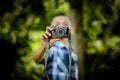 Boy Outdoors Holding Small Camera