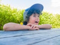 Boy at outside table resting chin on arms Royalty Free Stock Photo