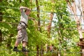 A boy overcomes obstacles, walking on a rope