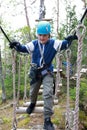 Boy overcoming swinging logs obstacle Royalty Free Stock Photo