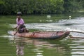 A boy paddles his outrigger canoe on the Madu River in Sri Lanka. Royalty Free Stock Photo