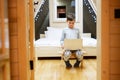 Boy in pajama sit with laptop at wooden cabin home. Concept of childhood, leisure activity, happiness