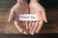 A boy with a paper note in his hands with the words THANK YOU Royalty Free Stock Photo