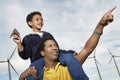 Boy With Paper Plane Sitting On Father's Shoulders Royalty Free Stock Photo